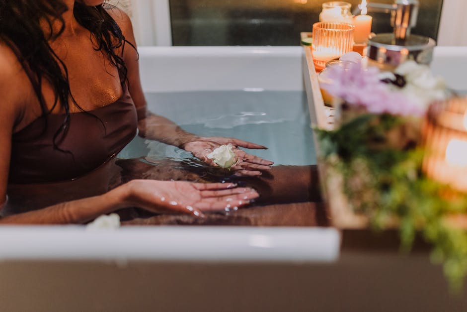 Serene spa bath experience with aromatic candles and fresh flowers promoting relaxation and tranquility